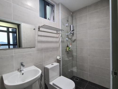 a bathroom with a white toilet and a sink at Alpine Parkland Netflix 5 beds at MRT Batu 11 Cheras in Cheras