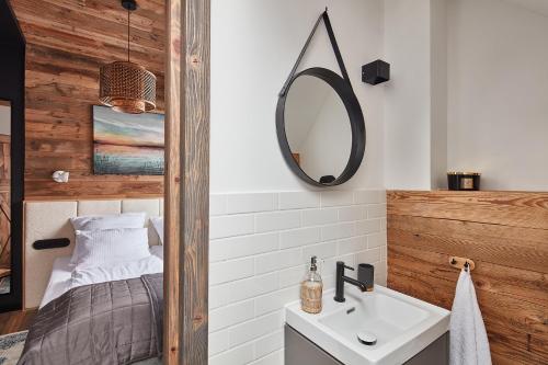 a bathroom with a sink and a mirror at HighZen Pozezdrze in Pozezdrze