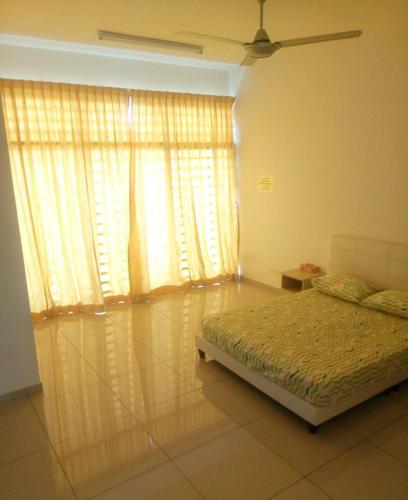 a bedroom with a bed and a large window at Penang holiday villa in Jelutong