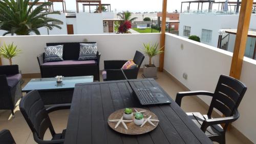 balcón con mesa y sillas en el techo en Alquilo casa de playa Condominio Playa Azul cerca de Asia, en Cerro Azul