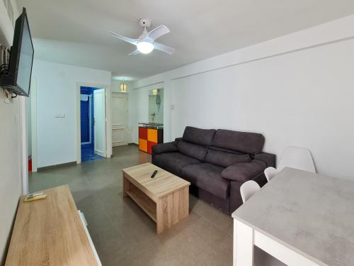 een woonkamer met een bank en een tafel bij Apartamento Completo Vera Rincon de Loix in Benidorm
