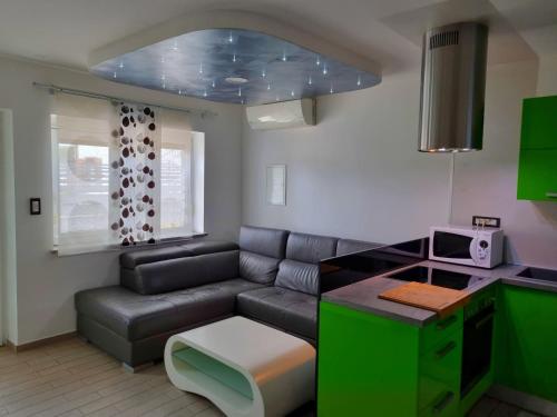 a living room with a couch and a table at Apartma Piko in Koper