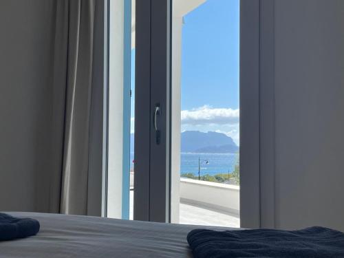 a bedroom with a window with a view of the ocean at Domus de Diana in Olbia