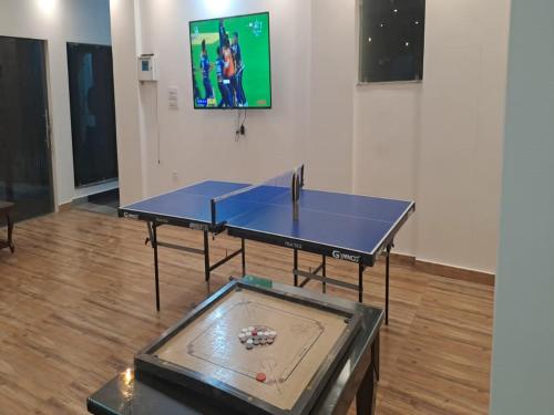 a blue ping pong table in a room with a tv at LA Riqueza Dhanolti View # Mountain View Rooms # Parking # Lift # Near to Eco Park & Surkanda Devi Temple in Dhanaulti