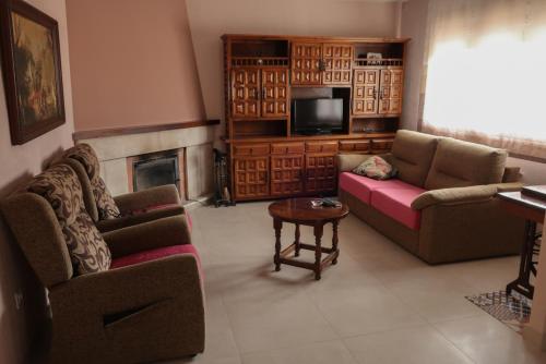 Sala de estar con 2 sofás y TV en Casa Balbi, en Canales
