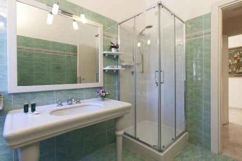 a bathroom with a shower, sink, and tub at Baia D'Argento in Porto Santo Stefano