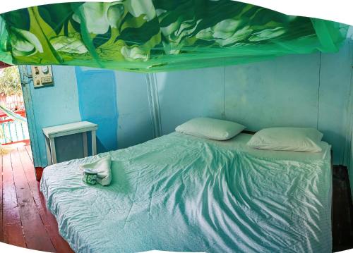 Ένα ή περισσότερα κρεβάτια σε δωμάτιο στο Don Det Mr.B Riverside Budget Guesthouse
