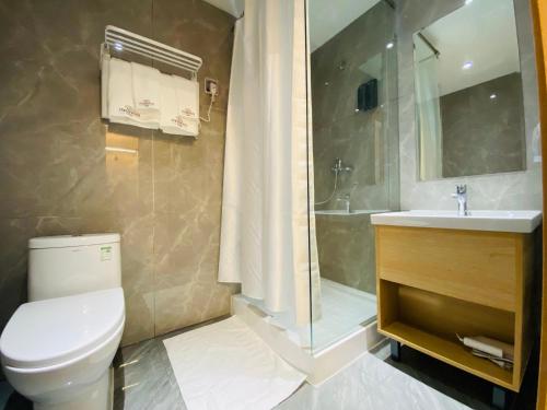 a bathroom with a toilet and a sink and a shower at Mazaalai Hotel 