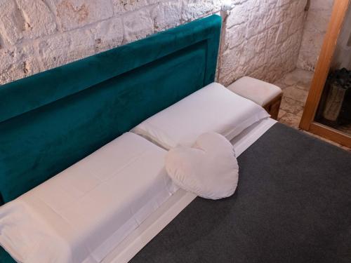 a bench with a heart shaped pillow on it at Dama Bianca Boutique Hotel Ostuni in Ostuni