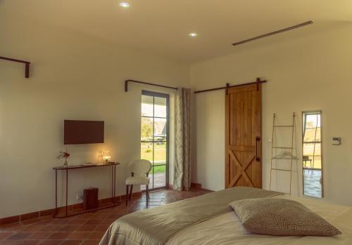 a bedroom with a bed and a desk and a window at Kili Seasons Hotel in Arusha