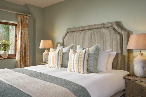 a bedroom with a large bed with pillows at The Newbridge on Usk in Usk