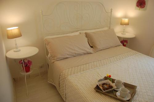 a bedroom with a bed with a tray of food on it at Appartamento Giovanni in Lido Adriano