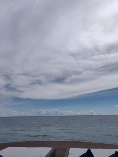 a view of the ocean under a cloudy sky at Arasatu Villas & Sanctuary in Maratua Atoll