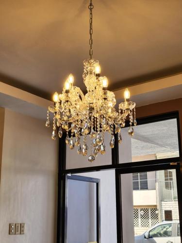 a chandelier hanging in front of a window at Mantra Pensionne Superior Room in Cagayan de Oro