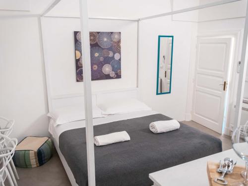 a bedroom with a bed with two pillows on it at Dama Bianca Boutique Hotel Ostuni in Ostuni