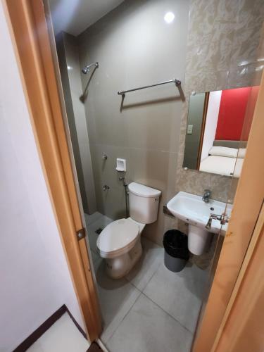 a bathroom with a toilet and a sink at Mantra Pensionne Superior Room in Cagayan de Oro