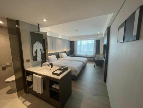 a large hotel room with a bed and a bathroom at Hotel Interburgo Exco in Daegu