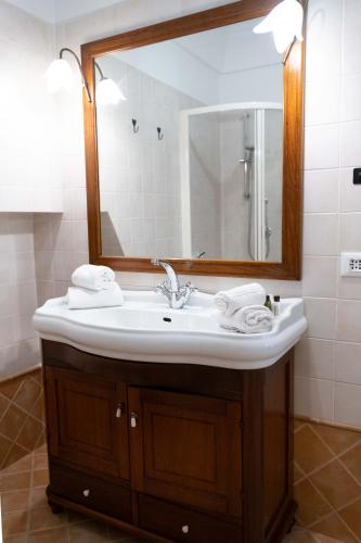 a bathroom with a sink and a mirror at Dama Bianca Boutique Hotel Ostuni in Ostuni