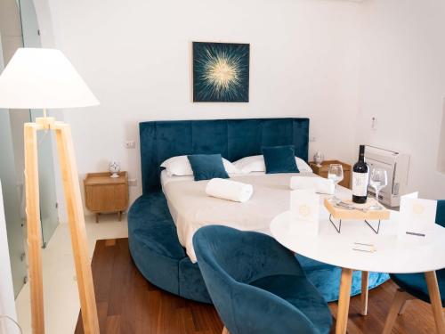 a bedroom with a bed and a table and chairs at Dama Bianca Boutique Hotel Ostuni in Ostuni