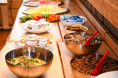 a buffet with bowls of food on a table at Chata Emil Zatopek - Maraton - Lysa Hora in Krásná