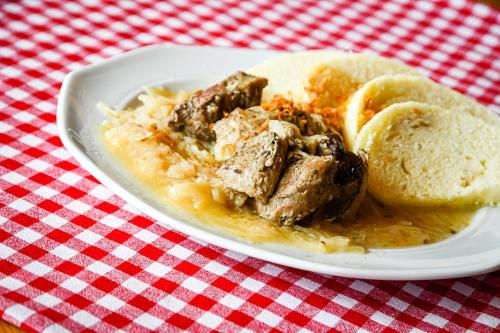 a white plate of food on a red and white table at Chata Emil Zatopek - Maraton - Lysa Hora in Krásná