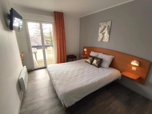 a bedroom with a bed and a large window at Kamea Club La Gironie in Turenne