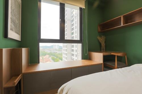 a bedroom with green walls and a bed with a window at Peaceful Studio w Pool for 3 Pax - Seri Kembangan in Seri Kembangan