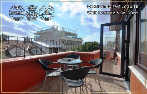 a patio with chairs and a table on a balcony at Angel's Home Hotel - Angel Group Hotels in Istanbul