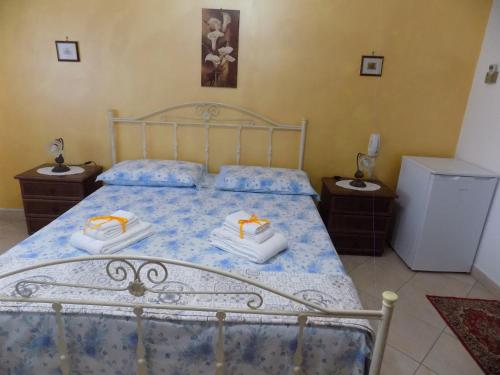 ein Schlafzimmer mit einem Bett mit zwei Handtüchern darauf in der Unterkunft B&B Le Cave in Avetrana