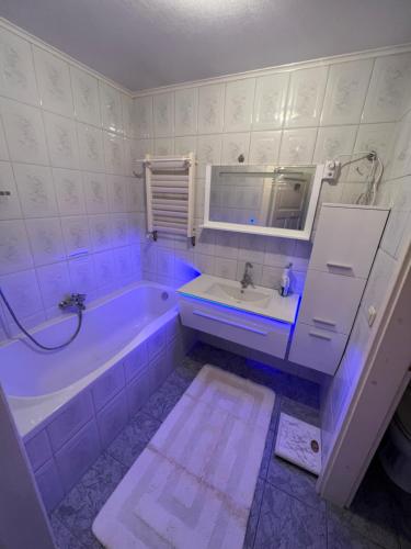 a white bathroom with a tub and a sink at Villa Altstadt Westhafen in Wismar