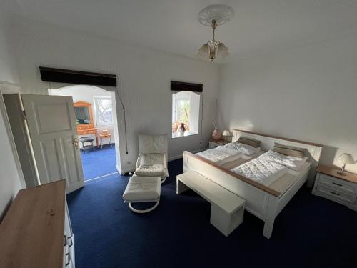 a bedroom with a bed and a chair in it at Villa Altstadt Westhafen in Wismar