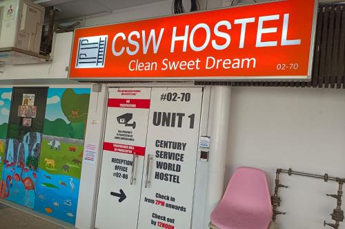 a sign for a csi hospital with a pink chair at CSW Hostel in Singapore