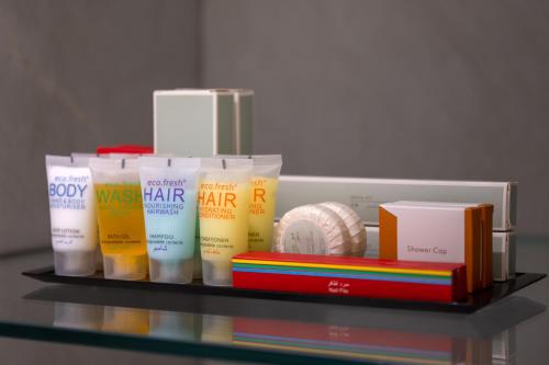 a shelf with several different types of hair products on it at Ramada Encore Doha by Wyndham in Doha