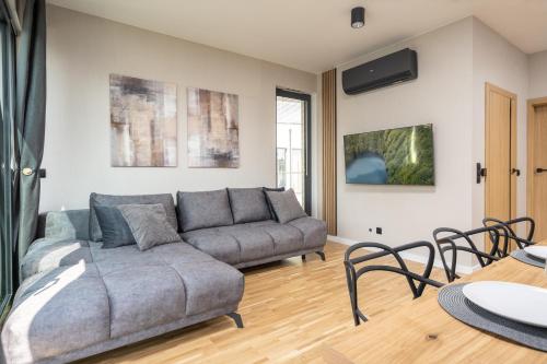a living room with a couch and a table at Apartamenty Olimpijska by RENT4YOU in Olsztyn