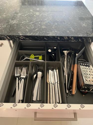 a drawer filled with utensils in a kitchen counter at Cozy new townhouse for 6 people! in Salalah