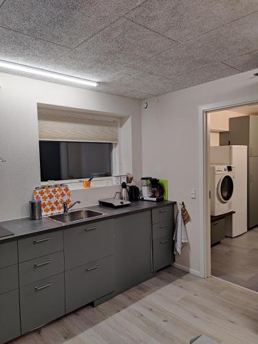 a large kitchen with a sink and a microwave at Villa-Amby in Ringkøbing
