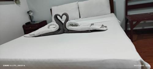 a bed with two swans made out of towels at duck inn manila in Manila