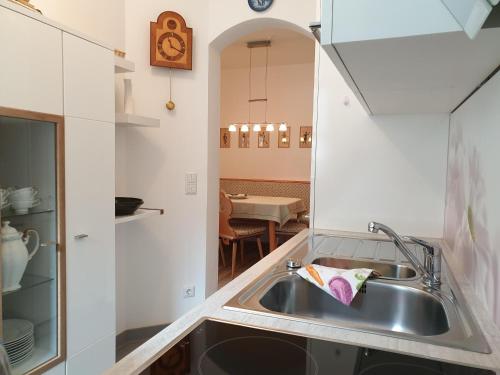 a kitchen with a sink and a counter top at Evelyn – Haus Karwendel, Ferienwohnung in Mittenwald
