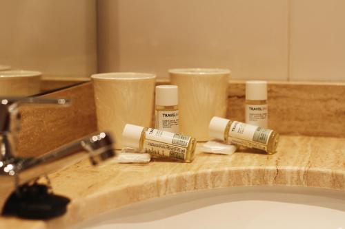 a bathroom sink with a bunch of products on a counter at Can Salvador in Miami Platja