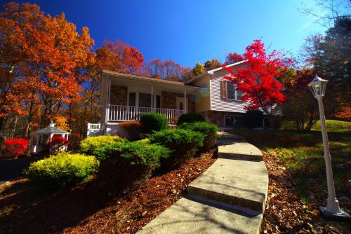 a house with a street light in front of it at Stunning Poconos Villa- Hot Tub, Pool, Game Room, BBQ & more in East Stroudsburg
