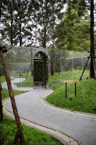 a batting cage in a park with a playground at Hotel Labaris Khao Yai in Mu Si