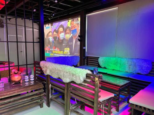 a room with purple and green seats and a screen at 20ft Sea Attic in Green Island