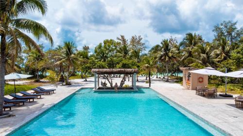 a pool at a resort with palm trees at BeachWalk Koh Rong in Koh Rong Island