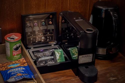 a coffee maker is sitting on a table with food at Hotel Labaris Khao Yai in Mu Si