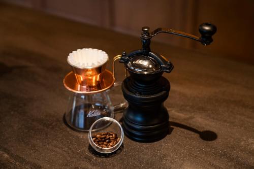 an old telephone and a cup of coffee on a table at The Hotel Seiryu Kyoto Kiyomizu - a member of the Leading Hotels of the World- in Kyoto
