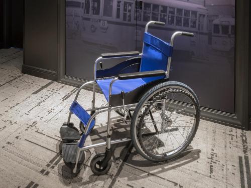 a blue wheelchair sitting in front of a building at GINZA HOTEL by GRANBELL in Tokyo