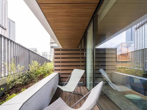 a balcony of a building with two chairs on it at GINZA HOTEL by GRANBELL in Tokyo