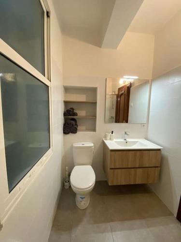 a white bathroom with a toilet and a sink at VibesCoruña- Ferrol 1D in Ferrol