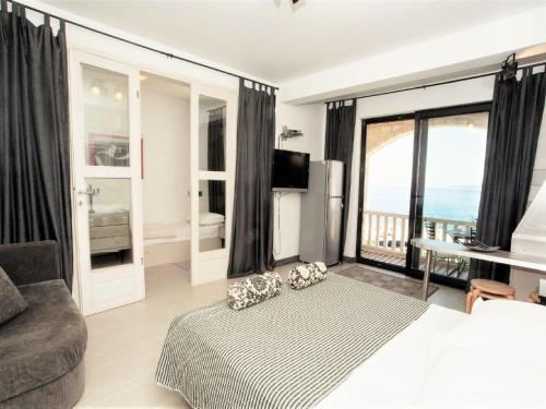 a living room with a bed and a view of the ocean at Apartments & Room Vesna in Brela