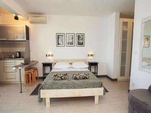 a bedroom with a bed and a kitchen at Apartments & Room Vesna in Brela